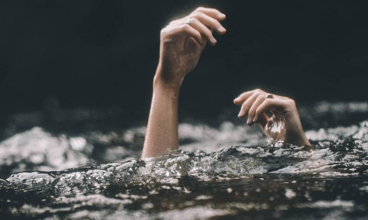 woman jumps into lake with